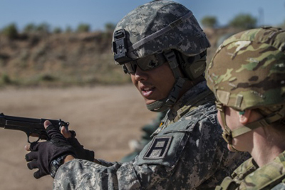 Army Reserve drill sergeant, Sgt. Robert Benavente, 95th Training Division (IET), provides some extra coaching to a Soldier preparing to deploy while firing the M9 at McGregor range in New Mexico.