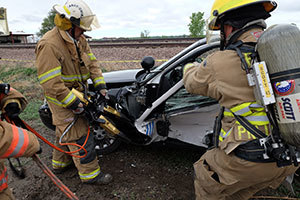 Firefighters practice extracting someone from a vehicle after a mock crash during the Chemical Stockpile Emergency Preparedness Program Exercise in May 2015.