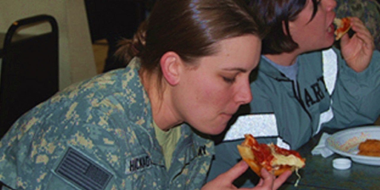 A soldier enjoys a delivery from Pizzas4Patriots