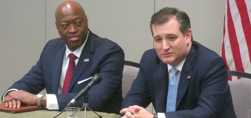 Event organizer John Burnett looks on as Ted Cruz talks