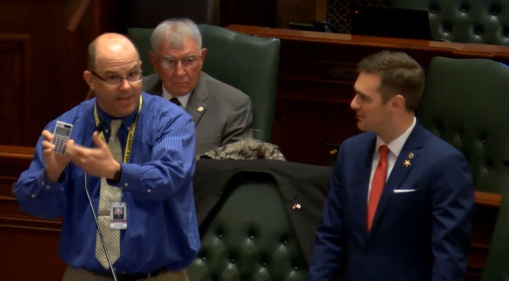 Rep. Mark Batinick (R-Plainfield) showing off calculator given to him by Rep. Robert Martwick (D-Chicago) at the May 29 House floor debate.
