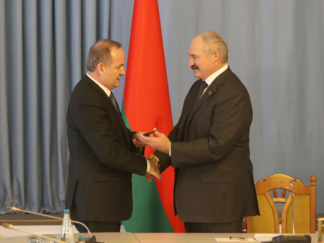 Belarus President Alexander Lukashenko, right, recently spoke at a ceremony at which he named the new chairman of the National Bank, Pavel Kallaur.