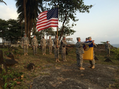 (From the left) Sgt. 1st Class Angel S. Morales and Col. Sven C. Erichsen lead Soldiers of the 48th Chemical, Biological, Radiological and Nuclear (CBRN) Brigade during the uncasing ceremony in support of Operation United Assistance at the U.S. Embassy in