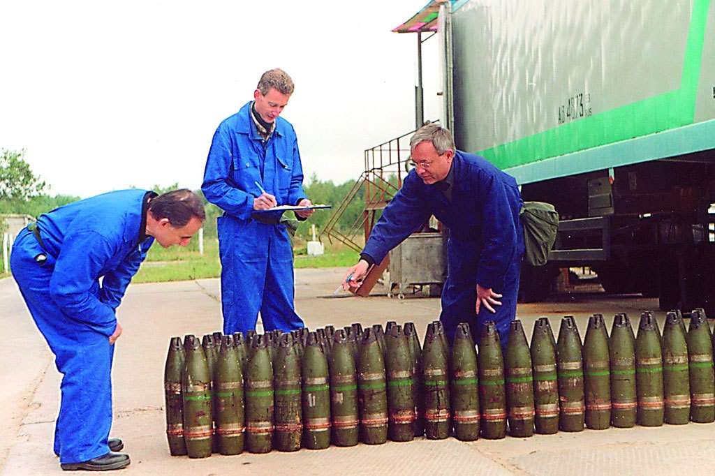 Inspectors from the Organisation for the Prohibition of Chemical Weapons (OPCW) inventory a stockpile of 22mm chemical artillery projectiles