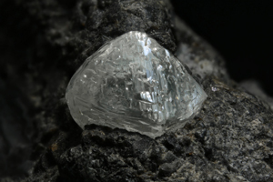 A sample of kimberlite with an exposed diamond.