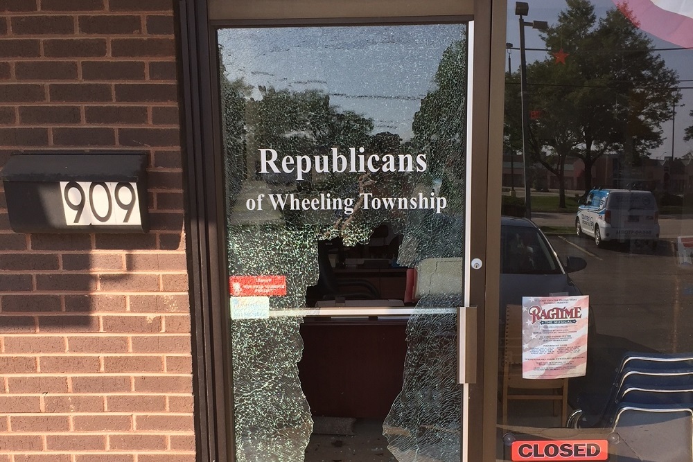 Large rectangular hole in the front door of Wheeling Township Republicans headquarters in Arlington Heights.