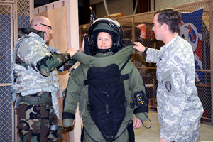 ECBC Scientist, Jennifer Sekowski is fitted with a protective suit against explosives.