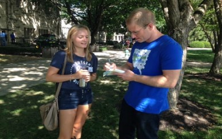 Kelsey Timmerman signs a book for a student after his speech at Butler.