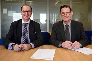 The University of Bristol's Andrew Nix, left, engineering faculty dean, and NNL Chief Scientist Andrew Sherry sign a memo of understanding to collaborate on nuclear energy.