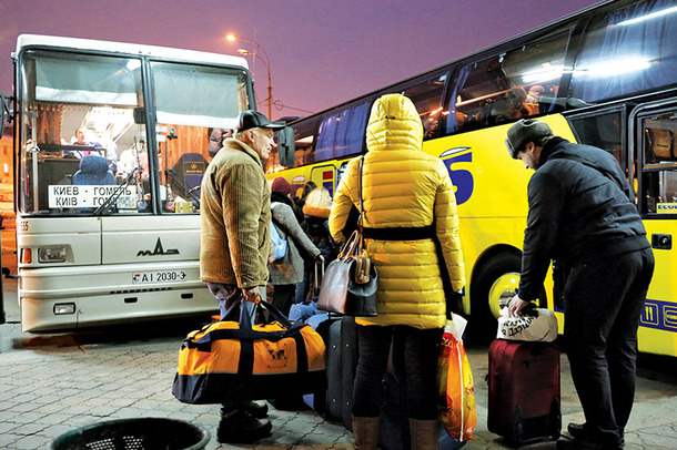 People at the Kyiv central bus station prepare to board a bus Wednesday. More people are using carpooling services to link up with other drivers to save money.