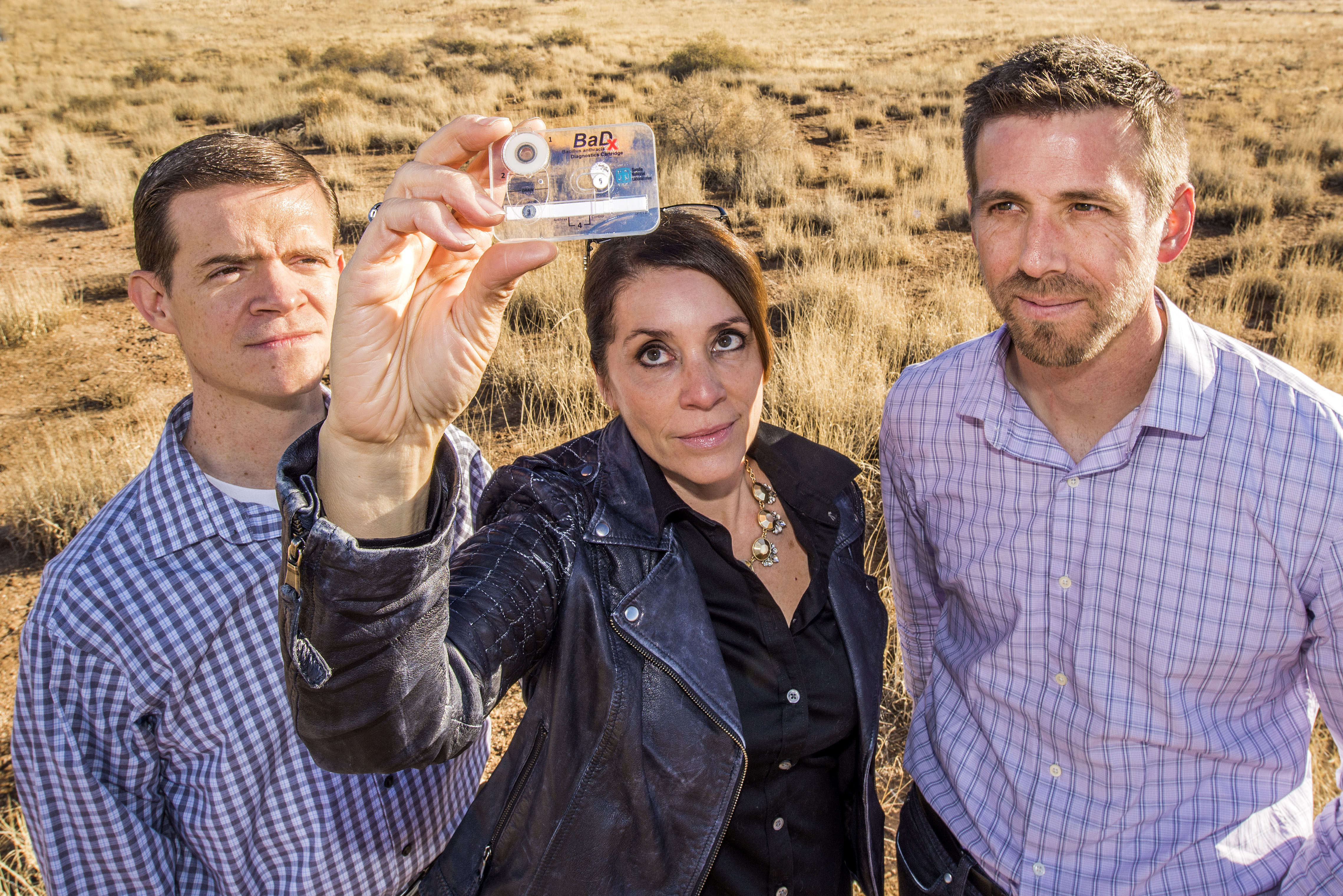 Sandia National Laboratories scientists, from left, Jason Harper, Melissa Finley and Thayne Edwards display a BaDx anthrax detector. The trio were recognized by the Federal Laboratory Consortium for their work in commercializing the BaDx technology.