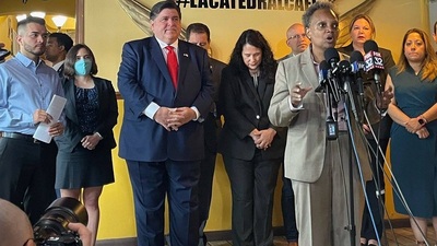 Chicago Mayor Lori Lightfoot speaking during a press conference in July. Democrat Gov. J.B. Pritzker is behind Lightfoot, to her right